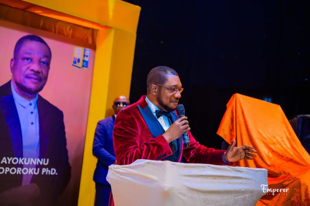 Dr. Ayokunnu Olowoporoku speaking at a lectern during the launch of SEE It, SAY It, DO It